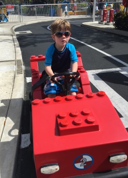 The Boy driving a firetruck on a track for 3 to 4 year olds only